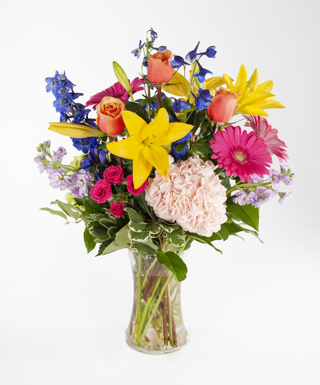 large vase with a variety of flowers in spring colors