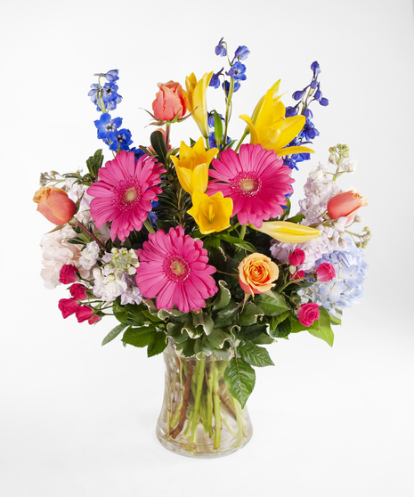 large vase with a variety of flowers in spring colors